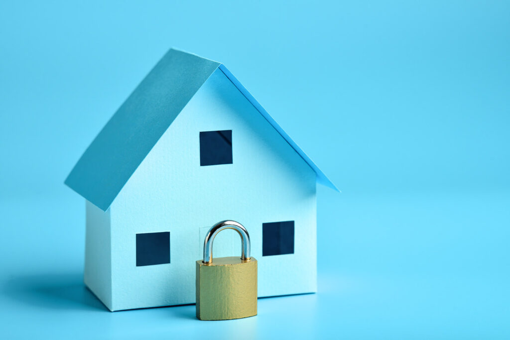 Model of a home next to a lock.