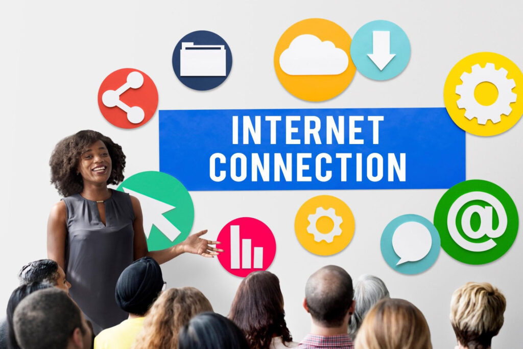 A woman presenter standing in front of a graphic that reads, “Internet Connection.