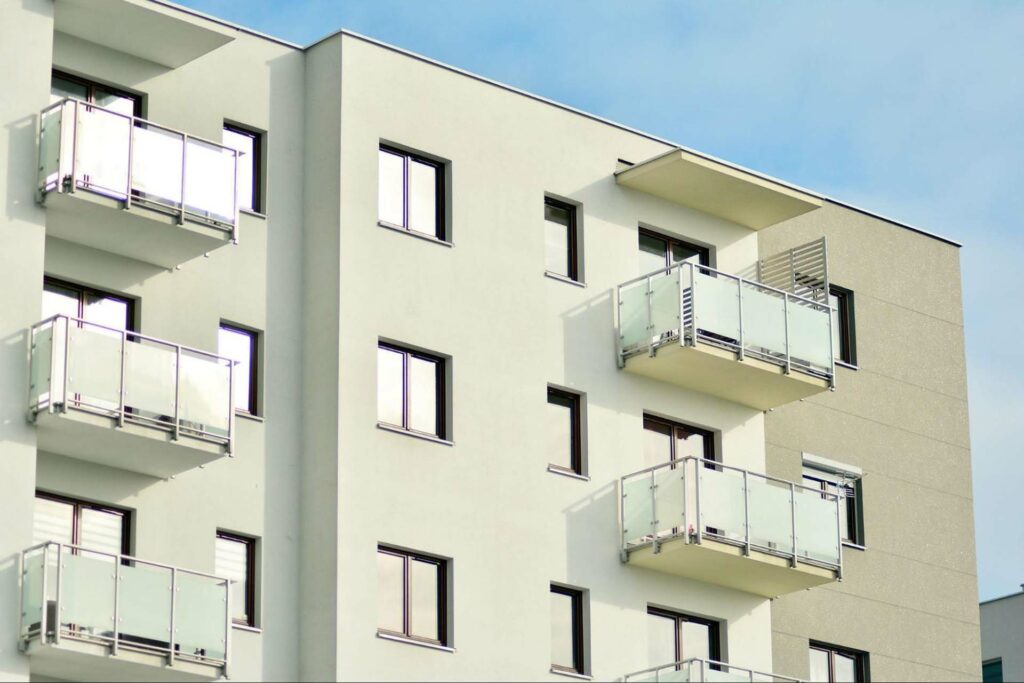 Outside view of an apartment building with windows and balconies.