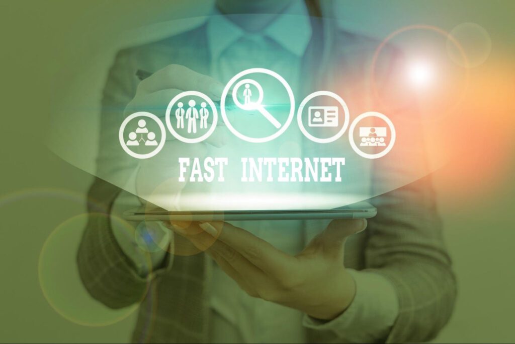 A woman in a suit holds a laptop. The words “fast internet” are shown in a graphic overlaid on the image.