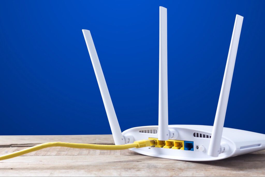 White internet router against a blue background.