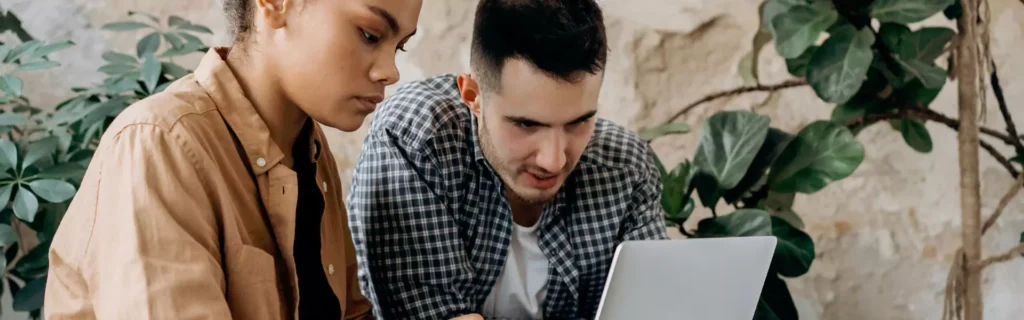 two people sitting together on their computers