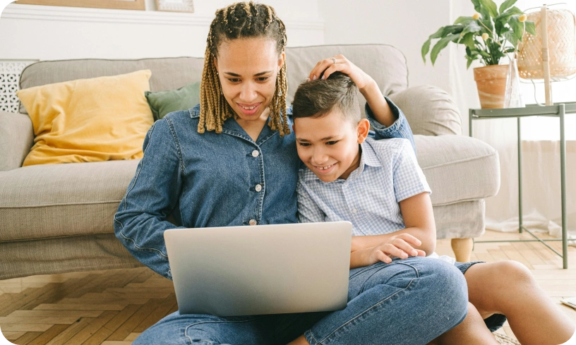 Mother and child enjoying time together on laptop.